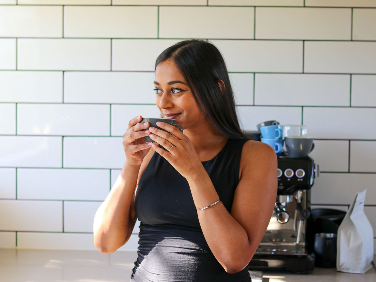 Woman drinking coffee at home
