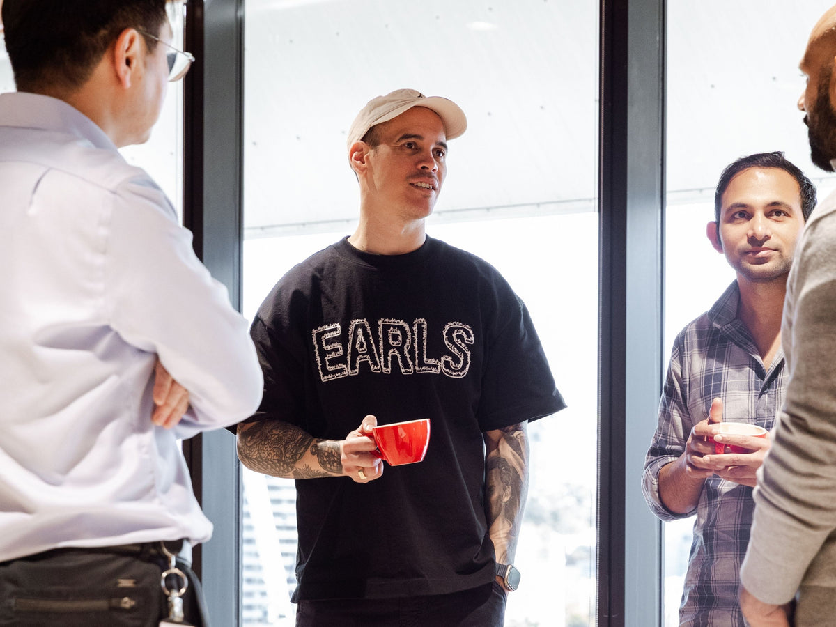 Staff drinking coffee together in their office